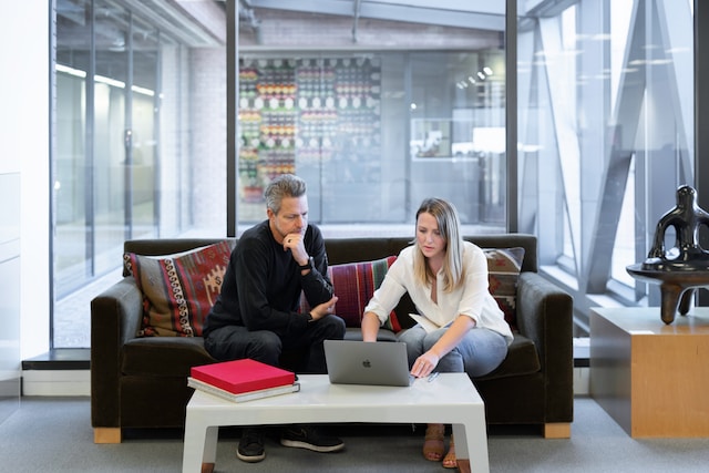 A man and a woman looking at a laptop.