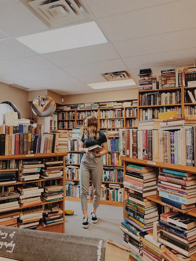 A woman browsing inside a bookstore.