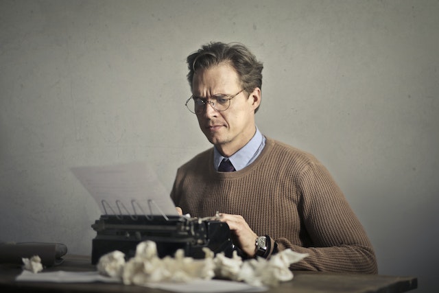 A man typing on a typewriter.