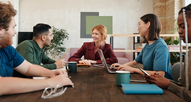 A group of people in a meeting. 