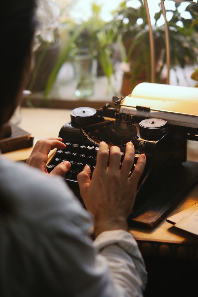 A guy using a typewriter.