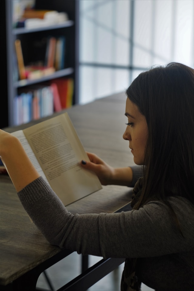 A woman intently reading a book