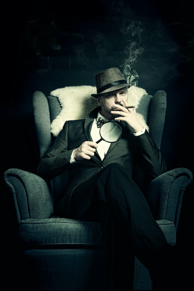 A well-dressed man smoking a cigar and holding a magnifying glass