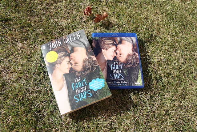 2 books lying on a grassy field