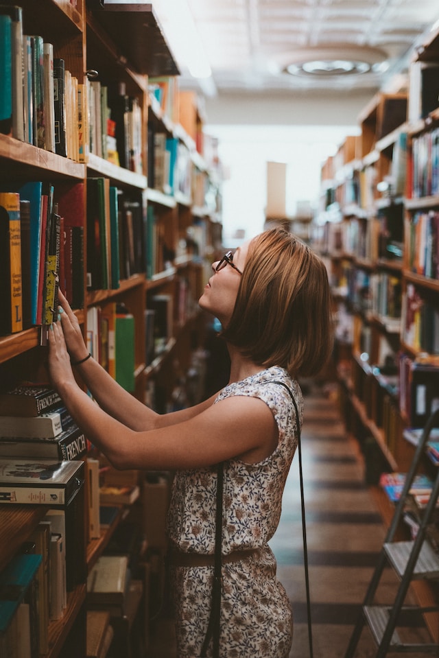 Woman browsing books at a library