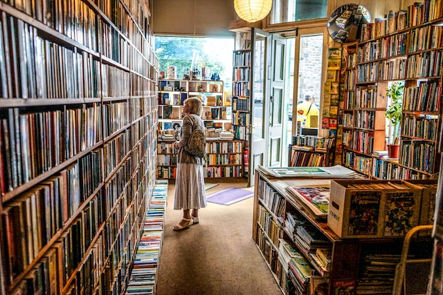 Woman browsing rows and rows of books inside a bookstore