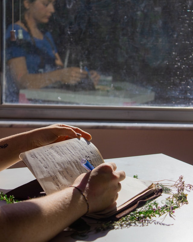 A woman writing on a notepad