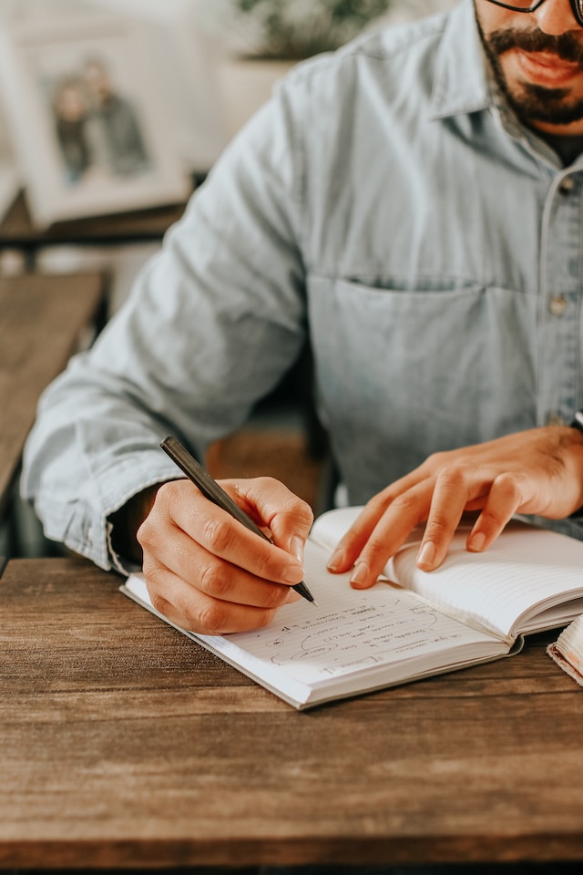 Person writing on a notepad