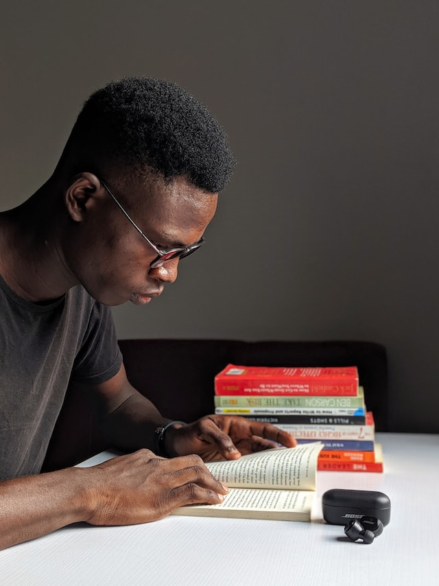 Guy reading a book at home