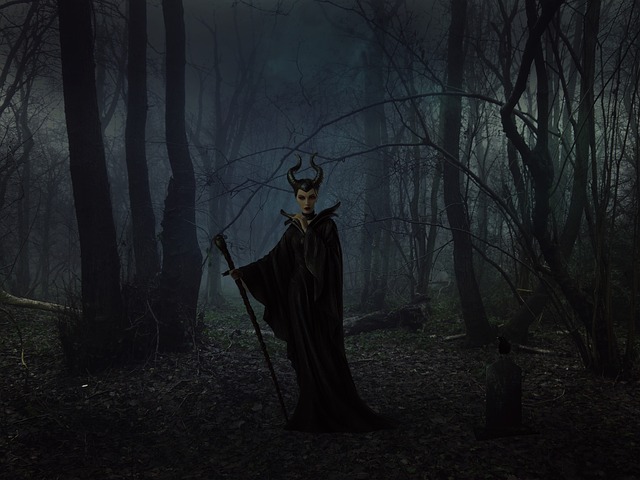 Horned woman in black in a dark forest